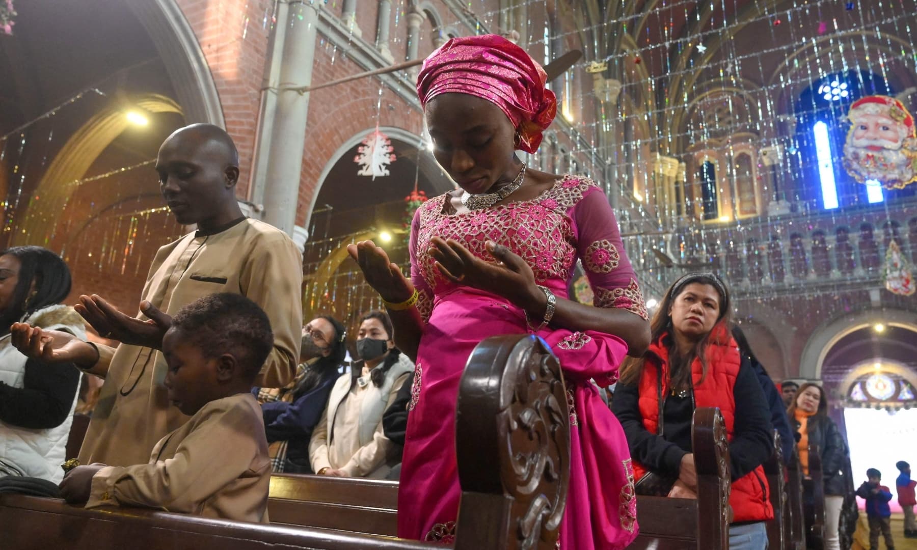 Christian devotees attend a prayer service at Sacred Heart Cathedral to celebrate Christmas in Lahore on December 25, 2021. — AFP