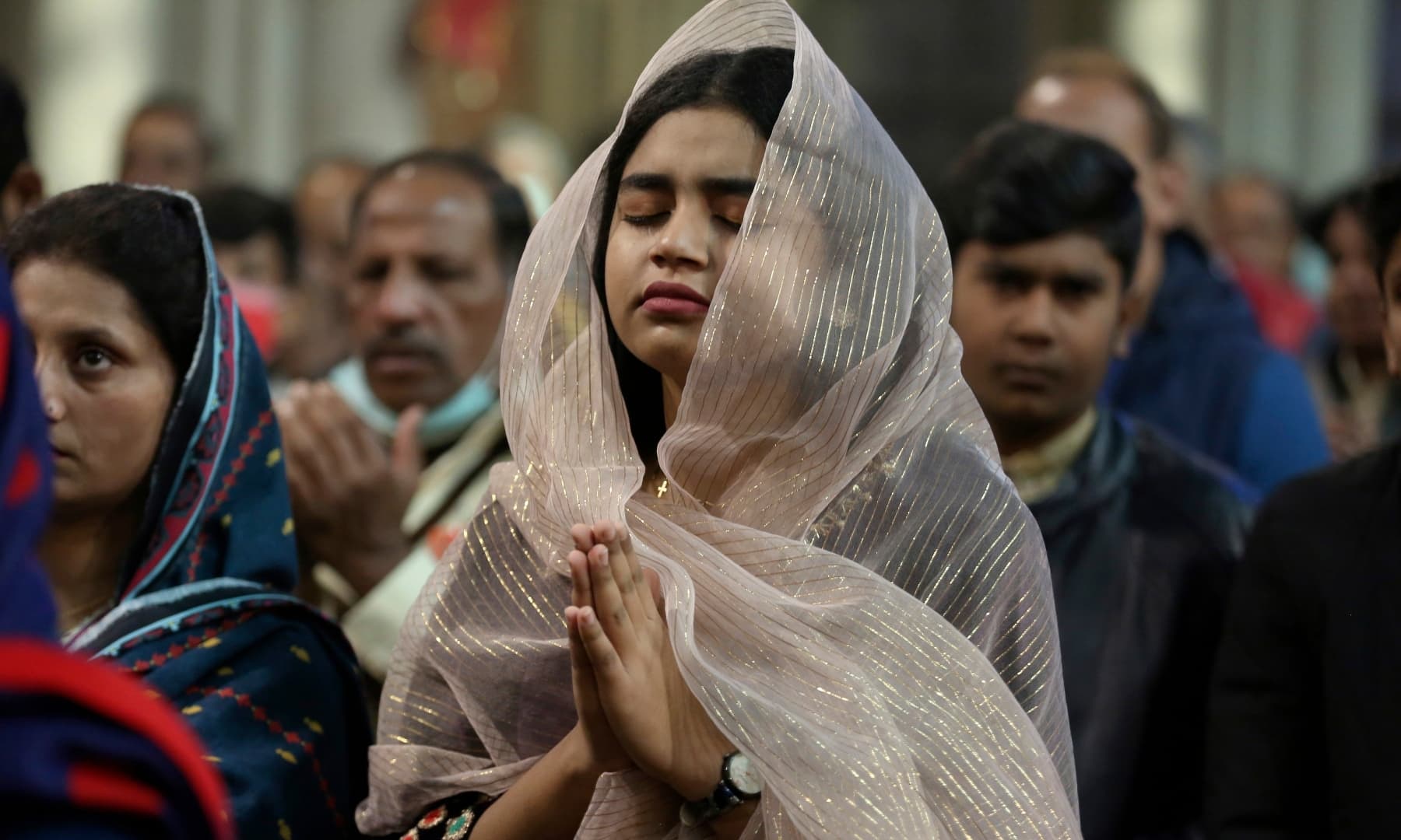 Devotees attend a Christmas mass at Sacred Heart Cathedral in Lahore on December 25, 2021. — AP