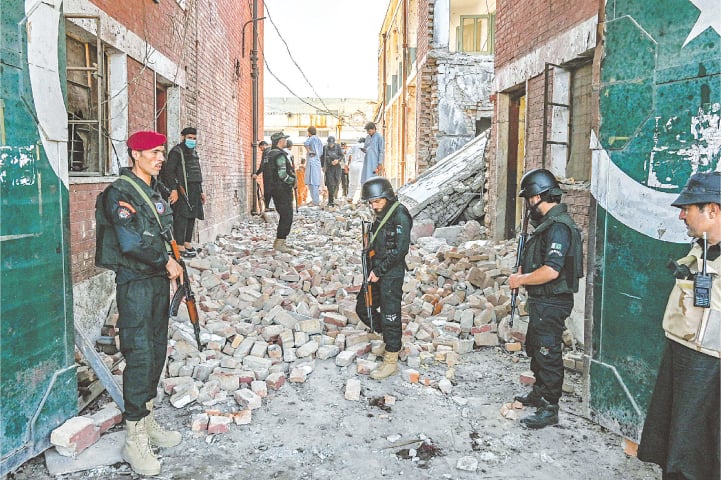 Security personnel inspect the site of a bomb blast in the Bara area of Khyber district, on Thursday.—AFP