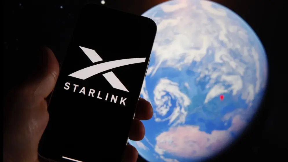 Starlink mobile app in front of an image of the Earth