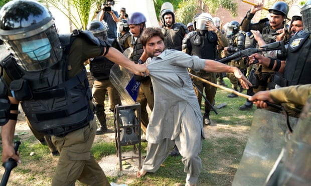 Police detain a supporter of Imran Khan in Lahore last month.