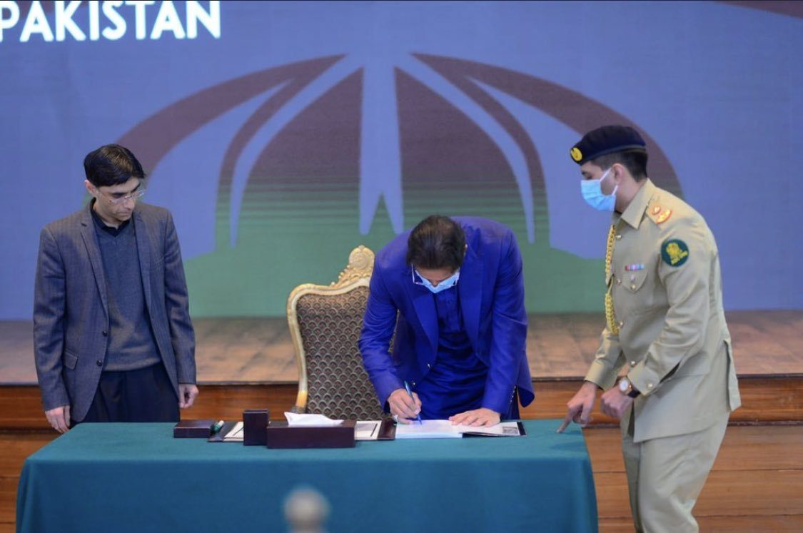 prime minister imran khan signs the public version of the national security policy photo pmo file