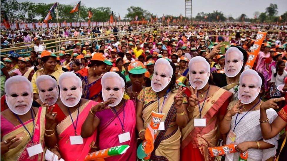 Supporters of Indias ruling Bharatiya Janata Party (BJP) wearing masks of Prime Minister Narendra Modi attend an election campaign rally addressed by Modi at Moran town in the northeastern state of Assam, India, March 30, 2019.