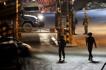 Israeli security forces patrol an area of a gun attack near Kiryat Arba in the West Bank on Saturday night.