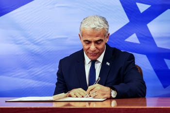 Israeli Prime Minister Yair Lapid signs a U.S.-brokered deal setting a maritime border between Israel and Lebanon last Thursday.