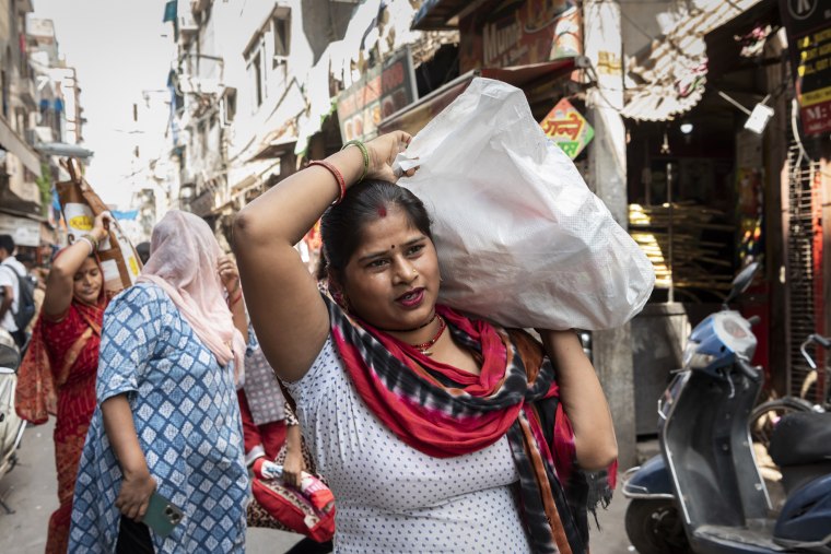 Raj Kumari heads home after shopping for ration and groceries at a local market in New Delhi, India, on Sept. 5, 2023.