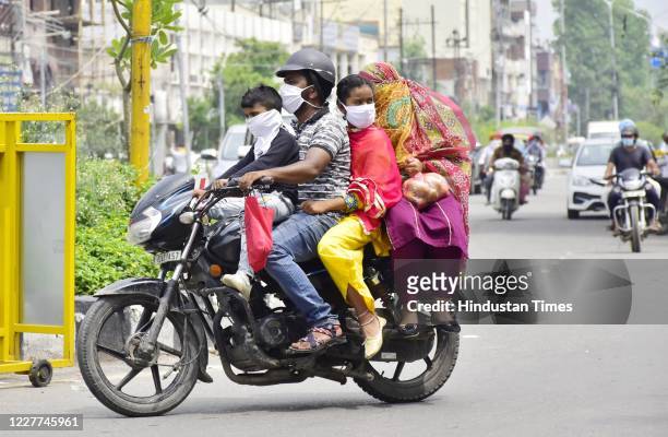 amritsar-india-july-22-a-family-of-four-travels-on-a-motorbike-flouting-traffic-and-social.jpg