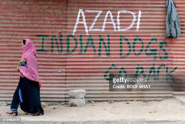 a-kashmiri-woman-walks-past-grafitti-that-reads-azadi-indian-dogs-go-back-home-during-curfew.jpg