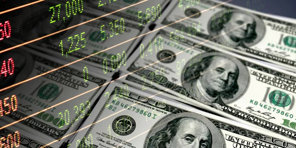 Economy graph: 100 dollar bills and stock market data dashboard - stock photo