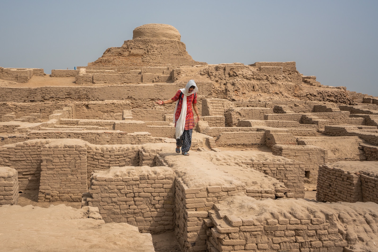Sindh travel guide - Alex walking on the ruins in Moenjo Daro - Lost With Purpose travel blog