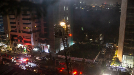 Fire service officials working to douse the fire on the 13th floor of the Khawaja Tower in Mohakhali, Dhaka on 26 October 2023.